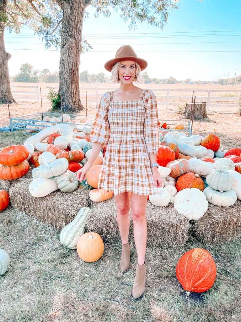 You'll be ready for fall in this adorable smocked plaid dress with the muted colors. 