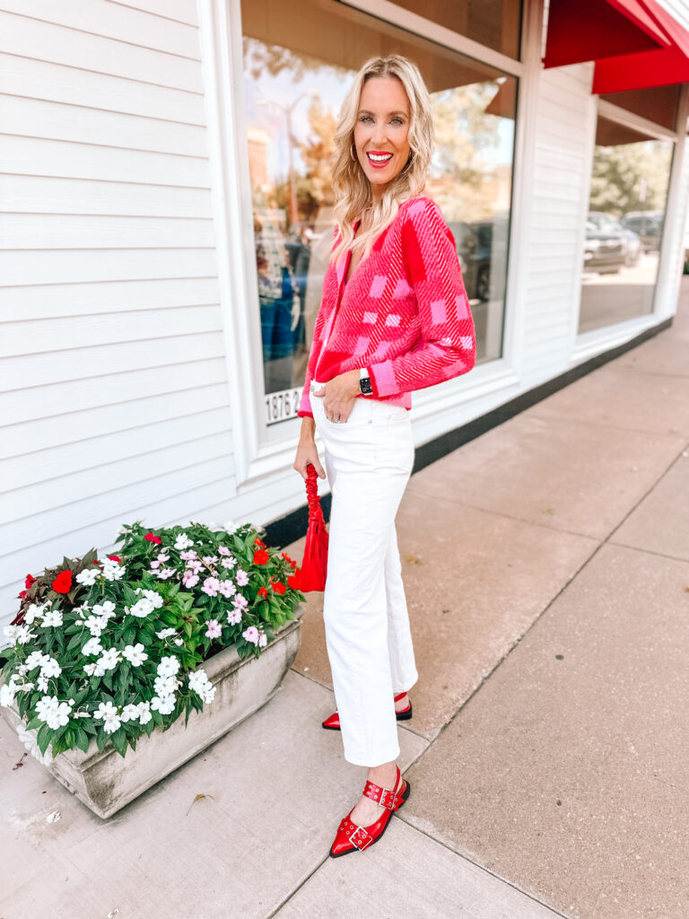 How amazing is this Amazon pink and red cardigan?! I styled it with cream jeans and red accessories for a fun fall look!