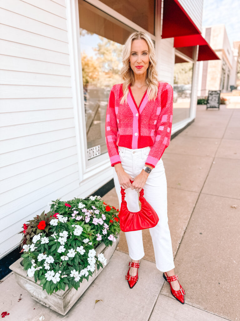 How amazing is this Amazon pink and red cardigan?! I styled it with cream jeans and red accessories for a fun fall look!